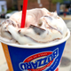 Illustration for article titled Dairy Queens Jurassic Chomp Blizzard is a giant cup of candy garnished with ice cream